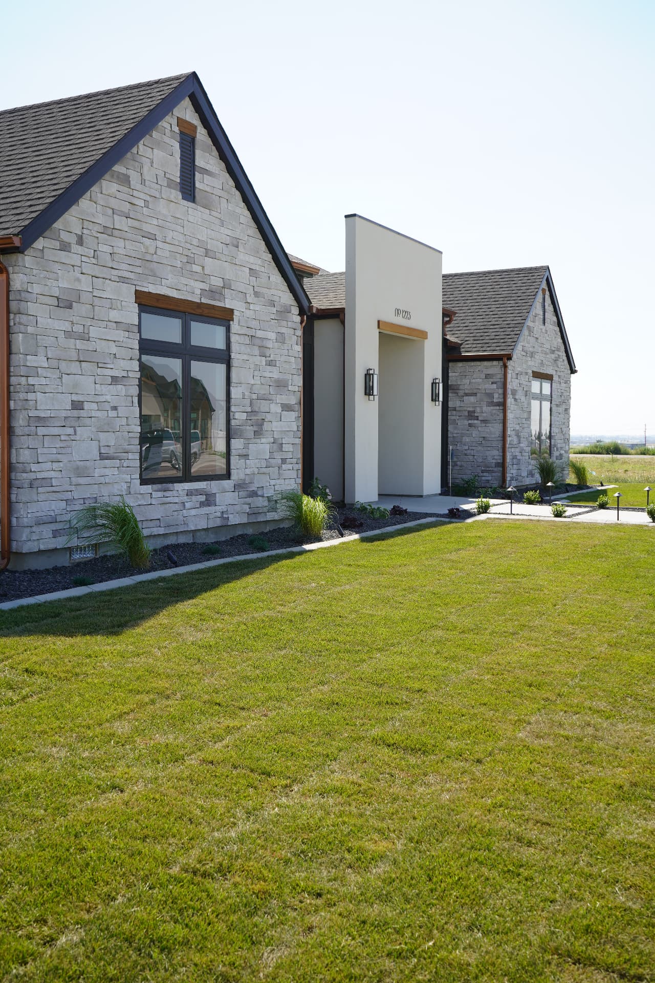 Beautifully finished sod lawn in front of a modern stone home