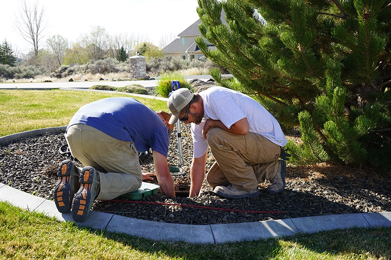 Hanks technicians performing backflow testing and irrigation service