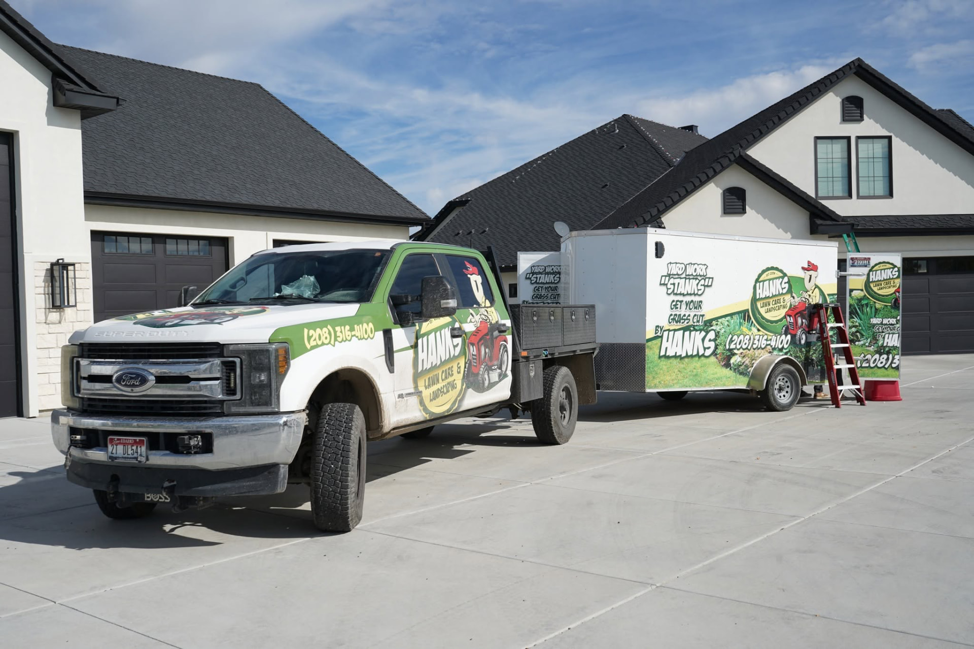 Hanks Custom Lawn Care branded truck and trailer ready for work