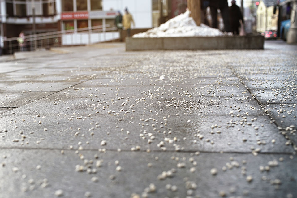 Rock salt on a sidewalk - Hanks Custom Lawn Care Snow Removal services