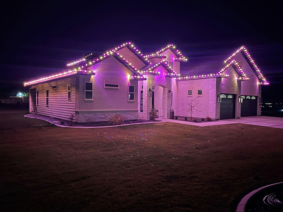 House with purple Christmas lights - Hanks Custom Lawn Care